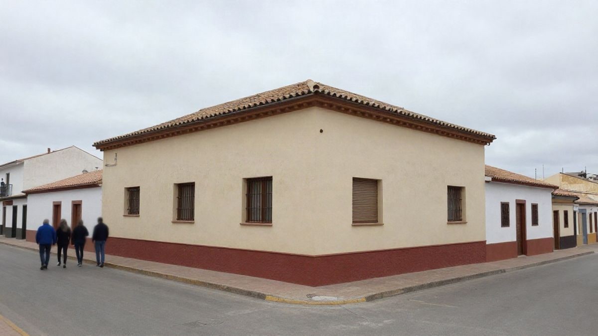 Imagen ilustrativa: fachada de una escuela con mochilas colgadas en la entrada, en un día nublado.