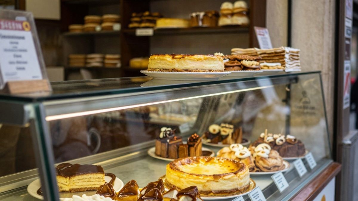 Imagen ilustrativa: un mostrador de pastelería con dulces tradicionales, entre ellos una tarta redonda de queso.